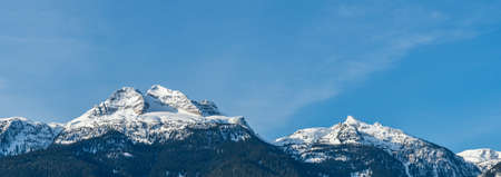 panorama of mountains with snow on top clear blue sky British Columbia Canada.の写真素材