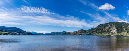 beautiful Skaha lake panorama with blue sky and white clouds summer morning.の写真素材