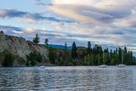 lake landscape with sailboats calm morning with cloudy sky.の写真素材