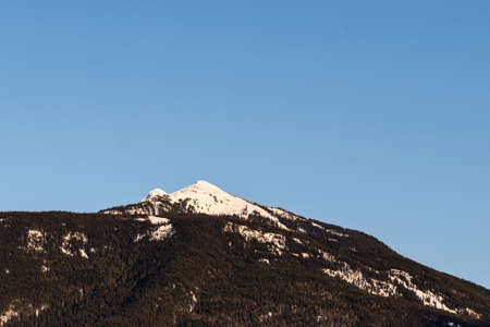 Beautiful snow-capped Columbia Mountains against the blue sky in British Columbia Canada.