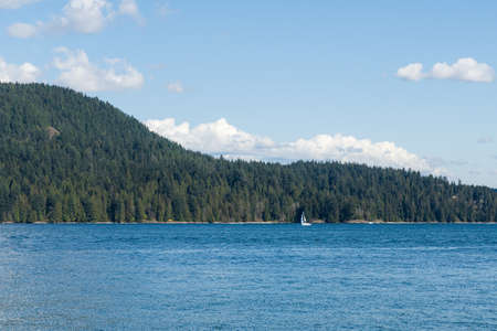 View to Indian Arm from North Vancouver Canada sunny spring day white clouds on blue sky.の写真素材