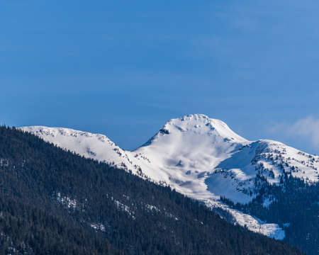 Beautiful snow-capped Columbia Mountains against the blue sky in British Columbia Canada.の写真素材