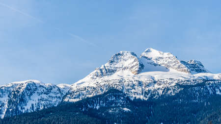 panorama of mountains with snow on top clear blue sky British Columbia Canada.の写真素材