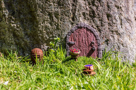 Fairy house door made from clay in stone wall.の写真素材
