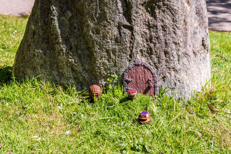 Fairy house door in huge stone fantasy world miniature setup.の写真素材