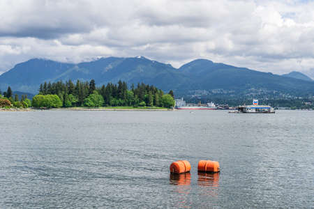 VANCOUVER, CANADA - MAY 15, 2020: Mountains view from Harbour Green Park Canada to North Vancouver shoreのeditorial素材