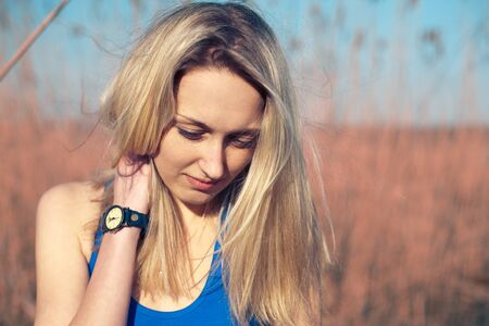 Beautiful blonde girl in the sun and wind