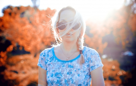 Beautiful young blonde woman in sunglasses in the sunshine