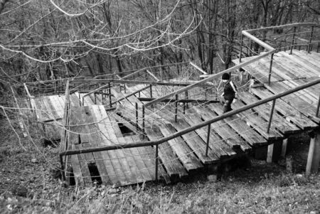 The wooden stairs with boy in spring parkの写真素材