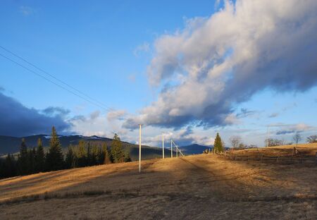 Perspective view on road in mountains. Beautiful clouds.
