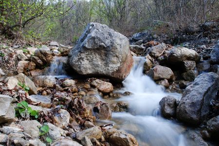 Waterfall in green mountain landscapeの写真素材