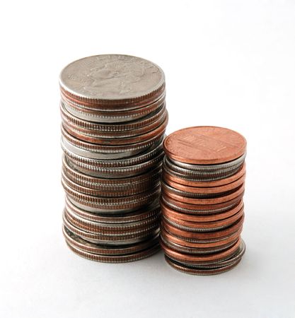 Two piles of coins isolated on white background, sideways
