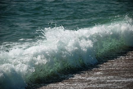 Sea clear wave surge on beach, transparent aquamarine pattern inside of water layer