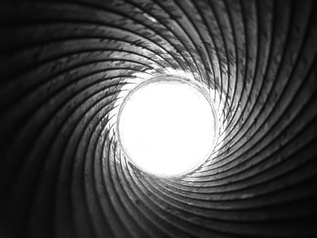 White disk with shiny steel spirals of rifling, view of cannon barrel on the inside, monochrome...