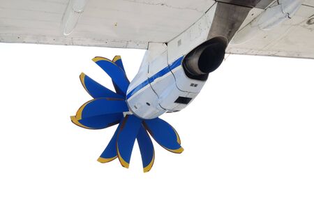 Engine with double blue propellers under white wing of commercial airplane, rear view