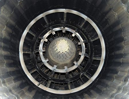 Turbine of military airplane from within, close up, metallic blades and circles, shining symmetric patternsの写真素材