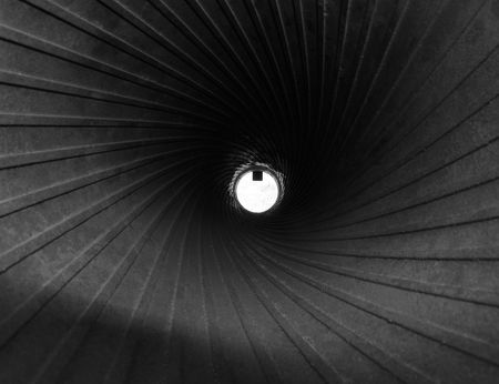 White disk with shiny steel spirals of rifling, view of cannon barrel on the inside, monochrome image   の写真素材
