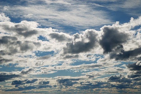 The blue sky with a lot of clouds is photographed by polarized light filter. The picture is made in the summer evening.の写真素材