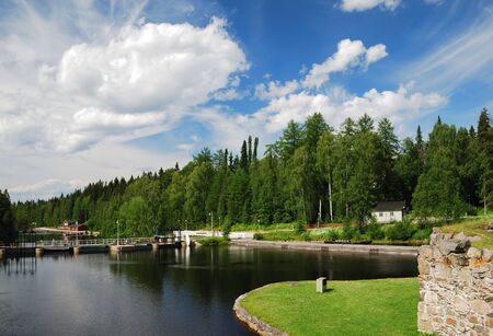 Finnish town Kajaani is photographed at lovely summer day. There are an island with ancient ruins, calm river, green forest and the fantastic sky. の写真素材