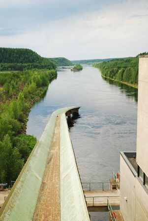 Finnish rapid river is running in the taiga forest. It is photographed from the small hydroelectric power plant. の写真素材