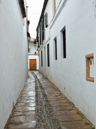 A narrow street is curving between the stone houses in the Spanish white town  Cordoba has the second largest old city in Europe  の写真素材