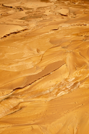 Yellow wet clay silt are photographed after the mud torrent  This is a rapid movement of a large mass of mud formed from loose soil and water の写真素材