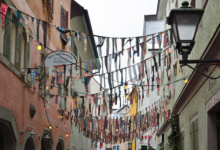 Narrow street of medieval city Konstanz is decorated with various cravats for the traditional...