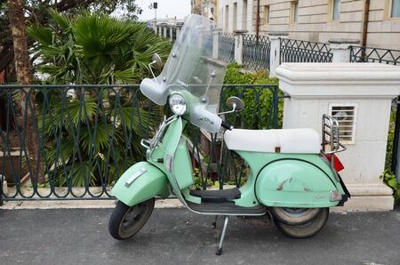 The old-fashioned scooter is parked in the narrow curve street of the ancient city Syracuse.のeditorial素材