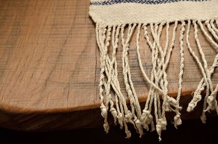 Ukrainian homespun towel with fringe on the vintage wooden tabletopの写真素材