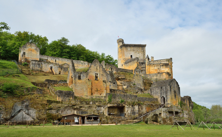 The ancient castle Commarque has been restoring on the forested hill in the green valley since 1994.の写真素材