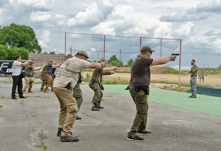 The civil men are trained to fire at the outdoor shooting range duringのeditorial素材