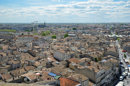 Bordeaux has one of the biggest 18th-century architectural urban areas in Europe. The modern constructions with the cranes tower in the remote district in the background.のeditorial素材
