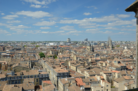 The ancient belfries of the Porte Caillhau and the cathedral tower above the old city. There are the modern buildings of the remote districts in the background.の写真素材