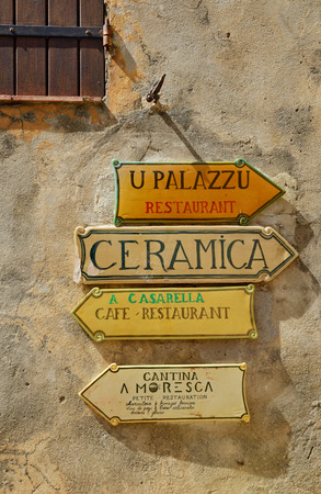 A few pointers on the wall of the Corsican village Pignaの写真素材