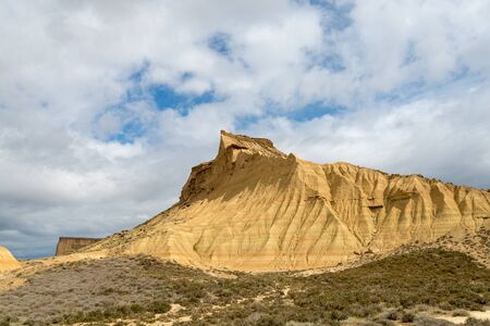 Steep mountain with a shrubby foothill in the badlands Bardenas Realesの写真素材