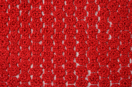 Home made embroidered with red threads canvas with home-woven fabric backgroundの写真素材