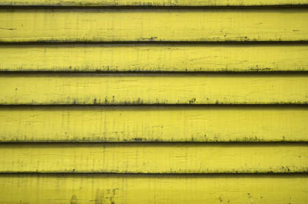 Background of yellow wooden wall house Bryggen street Bergen Norwayの写真素材