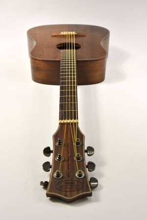 beautiful acoustic six-string guitar on a white backgroundの写真素材