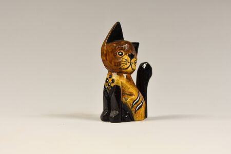 vintage wooden kitten figurine on a white backgroundの写真素材