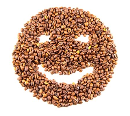 Roasted coffee beans placed in the shape of a smiling face isolated on white backgroundの写真素材