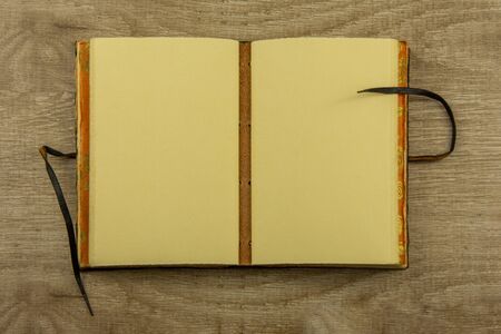 Vintage notebook on a wooden background Top view, flat layの写真素材