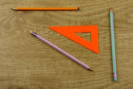 drawing ruler, pencil on a wooden background Top view, flat layの写真素材