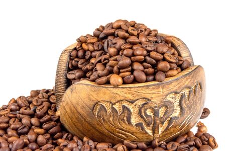 Roasted coffee beans spilling from a wooden box isolated on white backgroundの写真素材