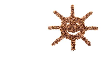 Roasted coffee beans placed in the shape of a smiling sun isolated on white backgroundの写真素材
