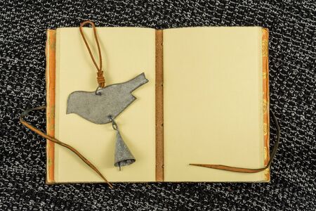 open vintage notebook on a background of knitted fabric in black top view flat layの写真素材
