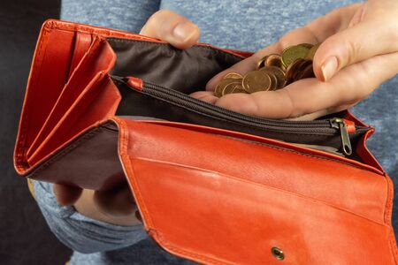 Earn quarantine. Woman puts coins in a purse