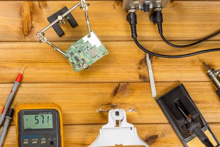 Tools for repairing phones, tablets and electronic equipment with copy space on a wooden background. Top view. Flat layの写真素材