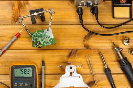 Tools for repairing phones, tablets and electronic equipment with copy space on a wooden background. Top view. Flat layの写真素材