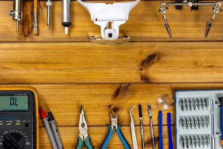 Tools for repairing phones, tablets and electronic equipment with copy space on a wooden background. Top view. Flat layの写真素材