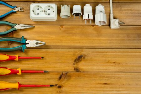 Electrician tool on wooden background with copy space. Top view. Flat lay